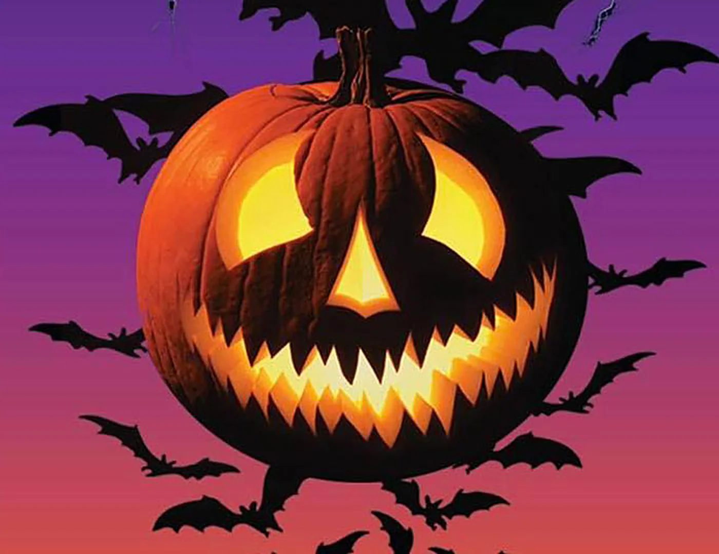 Jack-o-lantern and bats on a purple sky